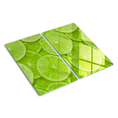 Glass chopping board Lime slices on a green background