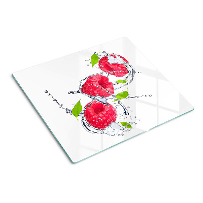Glass chopping board Raspberries in water with leaves