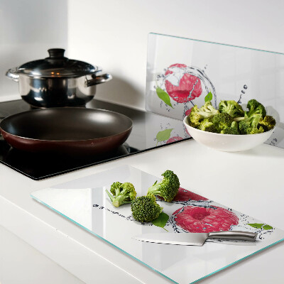 Glass chopping board Raspberries in water with leaves