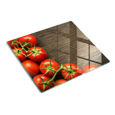 Glass chopping board Tomatoes on a wood background