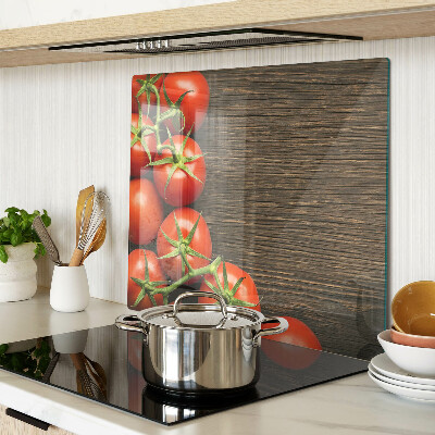 Glass chopping board Tomatoes on a wood background