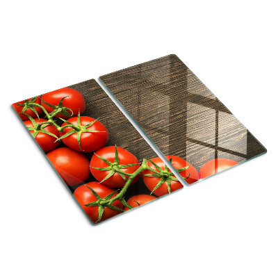Glass chopping board Tomatoes on a wood background