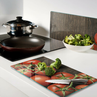 Glass chopping board Tomatoes on a wood background