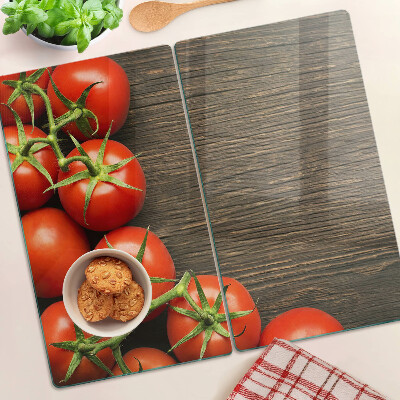 Glass chopping board Tomatoes on a wood background