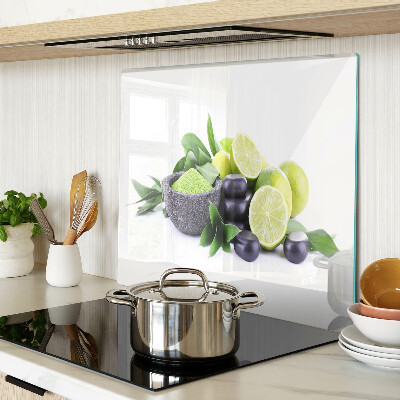 Glass chopping board Lemons and grapes on a green background