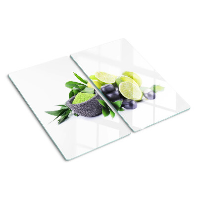 Glass chopping board Lemons and grapes on a green background