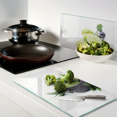 Glass chopping board Lemons and grapes on a green background
