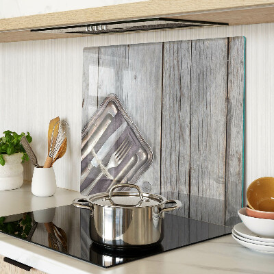 Glass chopping board Rustic cutlery on a wooden background