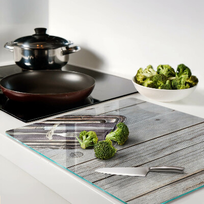 Glass chopping board Rustic cutlery on a wooden background