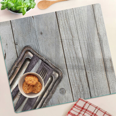 Glass chopping board Rustic cutlery on a wooden background