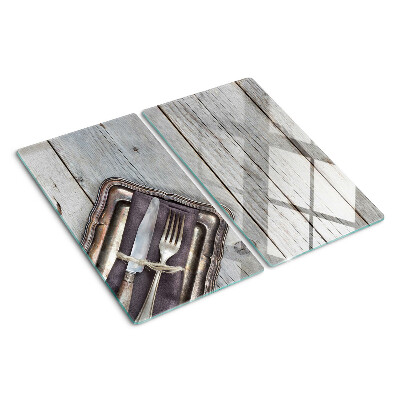 Glass chopping board Rustic cutlery on a wooden background