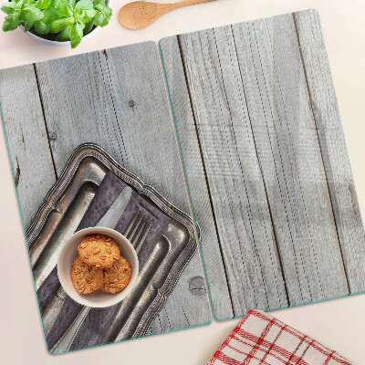 Glass chopping board Rustic cutlery on a wooden background