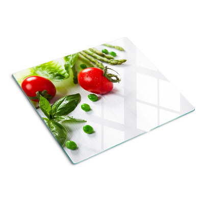 Glass chopping board Vegetables on a white countertop