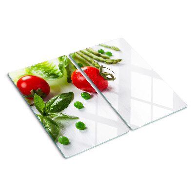 Glass chopping board Vegetables on a white countertop
