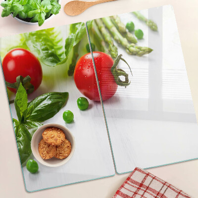 Glass chopping board Vegetables on a white countertop