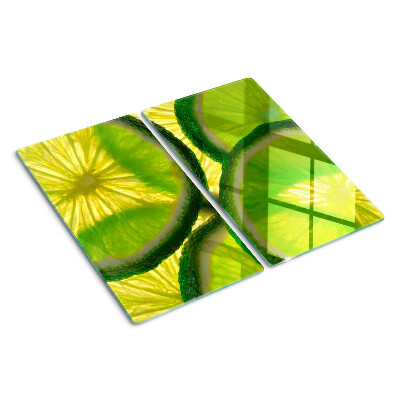 Glass kitchen board Lime slices on a green background