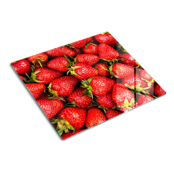 Glass chopping board Strawberries on a red background