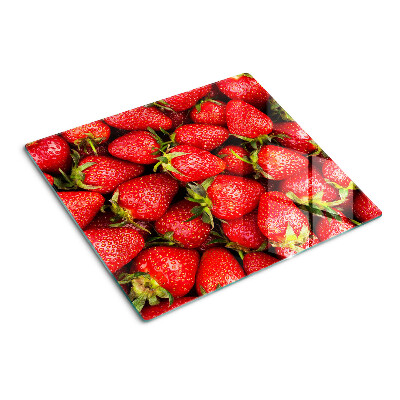 Glass chopping board Strawberries on a red background