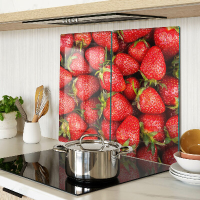 Glass chopping board Strawberries on a red background