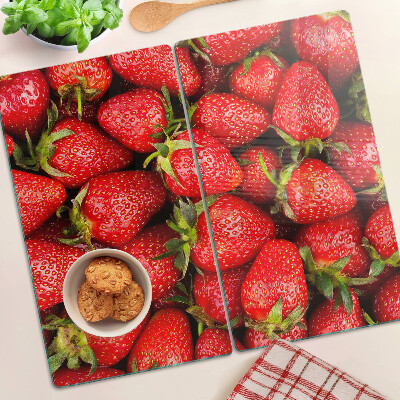 Glass chopping board Strawberries on a red background