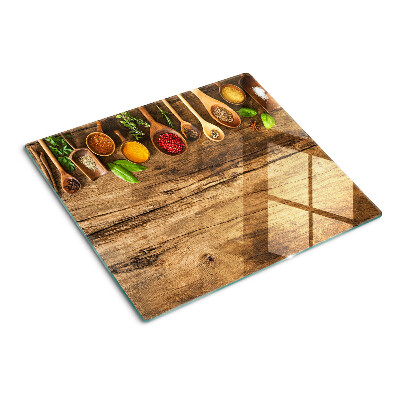 Glass kitchen board Spices and herbs on a wooden background