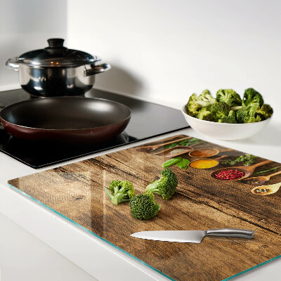 Glass kitchen board Spices and herbs on a wooden background