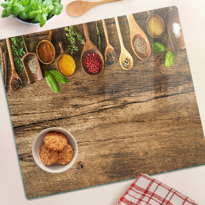 Glass kitchen board Spices and herbs on a wooden background