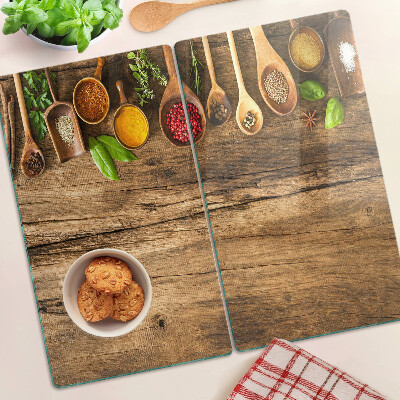 Glass kitchen board Spices and herbs on a wooden background