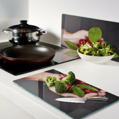 Glass chopping board Red cherries in hands