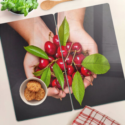 Glass chopping board Red cherries in hands
