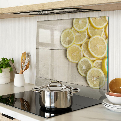 Glass chopping board Lemon slices on a wooden background