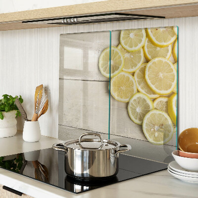 Glass chopping board Lemon slices on a wooden background