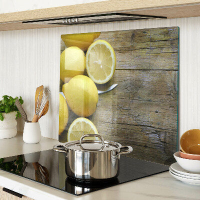 Glass chopping board Lemons on a wooden background