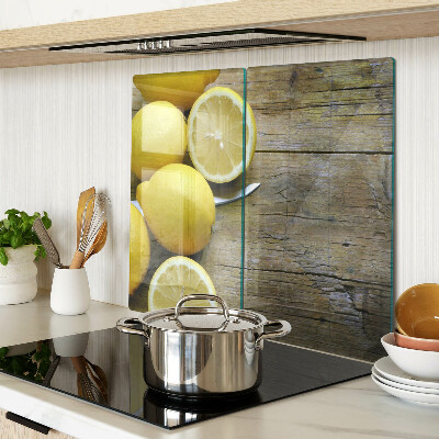 Glass chopping board Lemons on a wooden background