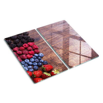 Glass chopping board Forest fruits on a wooden background