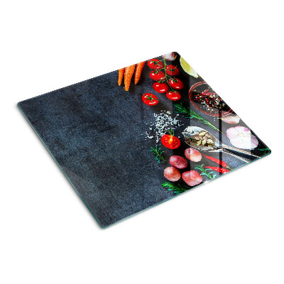 Glass kitchen board Vegetables and spices on a dark background