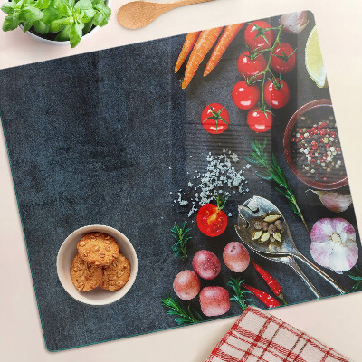 Glass kitchen board Vegetables and spices on a dark background