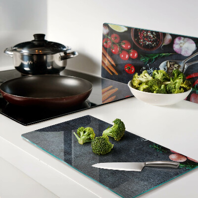 Glass kitchen board Vegetables and spices on a dark background
