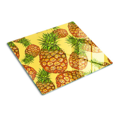 Glass kitchen board Pineapples on a yellow background