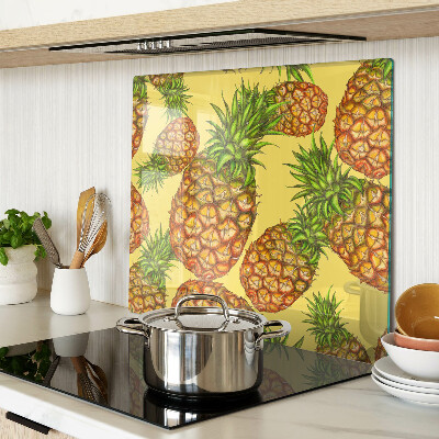 Glass kitchen board Pineapples on a yellow background
