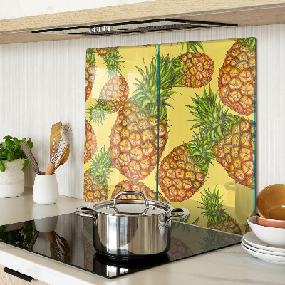 Glass kitchen board Pineapples on a yellow background
