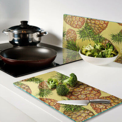 Glass kitchen board Pineapples on a yellow background