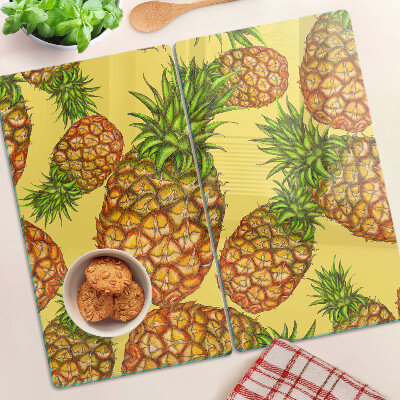 Glass kitchen board Pineapples on a yellow background