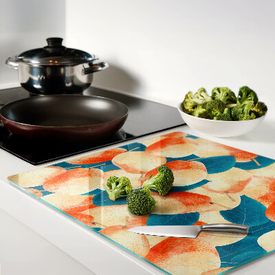 Glass chopping board Peaches against the background of leaves