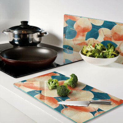 Glass chopping board Peaches against the background of leaves