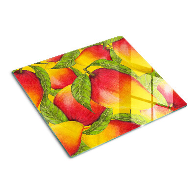 Glass chopping board Peppers on a background of green leaves