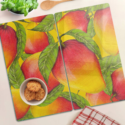 Glass chopping board Peppers on a background of green leaves