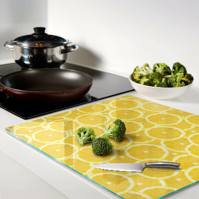 Glass kitchen board Lemon slices on a yellow background
