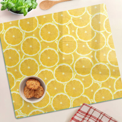 Glass kitchen board Lemon slices on a yellow background