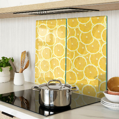 Glass kitchen board Lemon slices on a yellow background